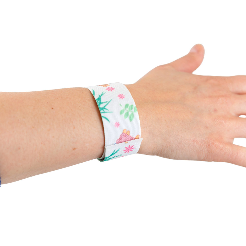 Snap wristband with llama design on a wrist against a white background