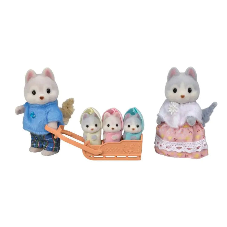 5 dog figures from the Sylvanian Families Husky Family set, with the 3 baby figures sitting in a sleigh