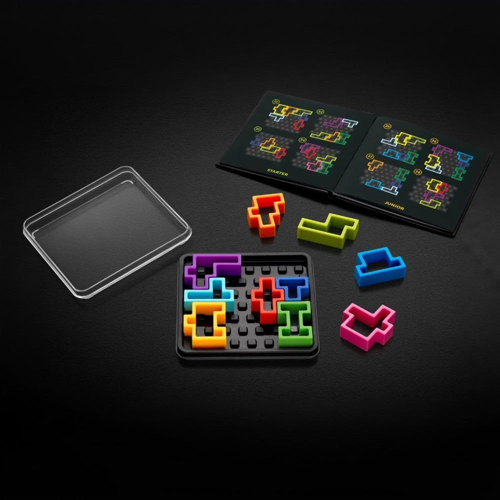 A colourful logic puzzle game set displayed on a dark background, including a clear square lid, a black square tray filled with brightly coloured pieces, loose coloured pieces, and the challenge book