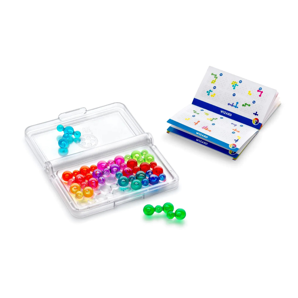 Colourful plastic bubble shaped pieces in an open container with a challenge book on a white background