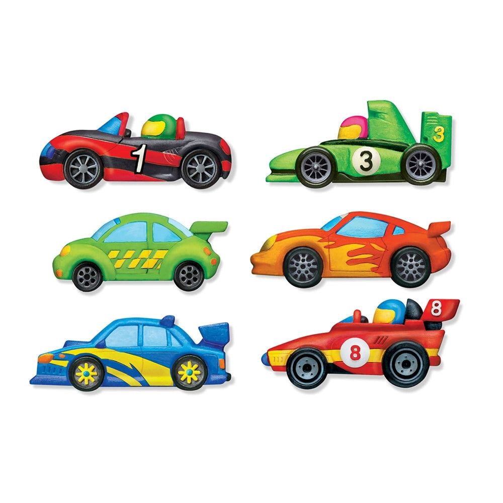 Set of colourful painted plaster race cars on a white background
