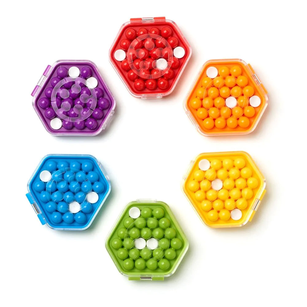A set of 6 different coloured IQ Mini Hexpert from Smart Games, a hexagonal shaped case with shaped playing pieces inside. With red, orange, yellow, green, blue and purple
