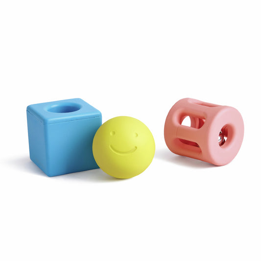 A set of three baby rattles of different geometric shapes on a white background