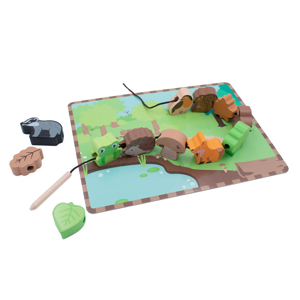 The Woodland themed lacing game from Jumini, with wooden figures including badger, hedgehog, fox, squirrel, bird, mushroom and leaves, all sitting on a scenery board and laced together with a thread