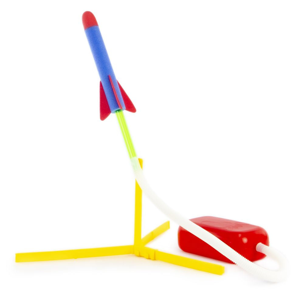 Colorful toy rocket launching from a launch pad on a white background