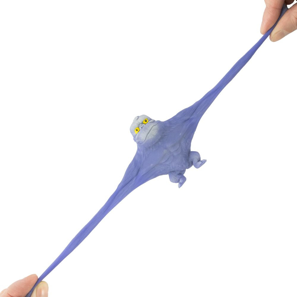 A blue stretchy gorilla fidget toy from Keycraft, being stretched between two hands on a white background