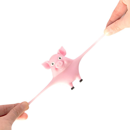 A pink Keycraft Stretch and Smash pig fidget toy getting stretched between 2 hands on a white background
