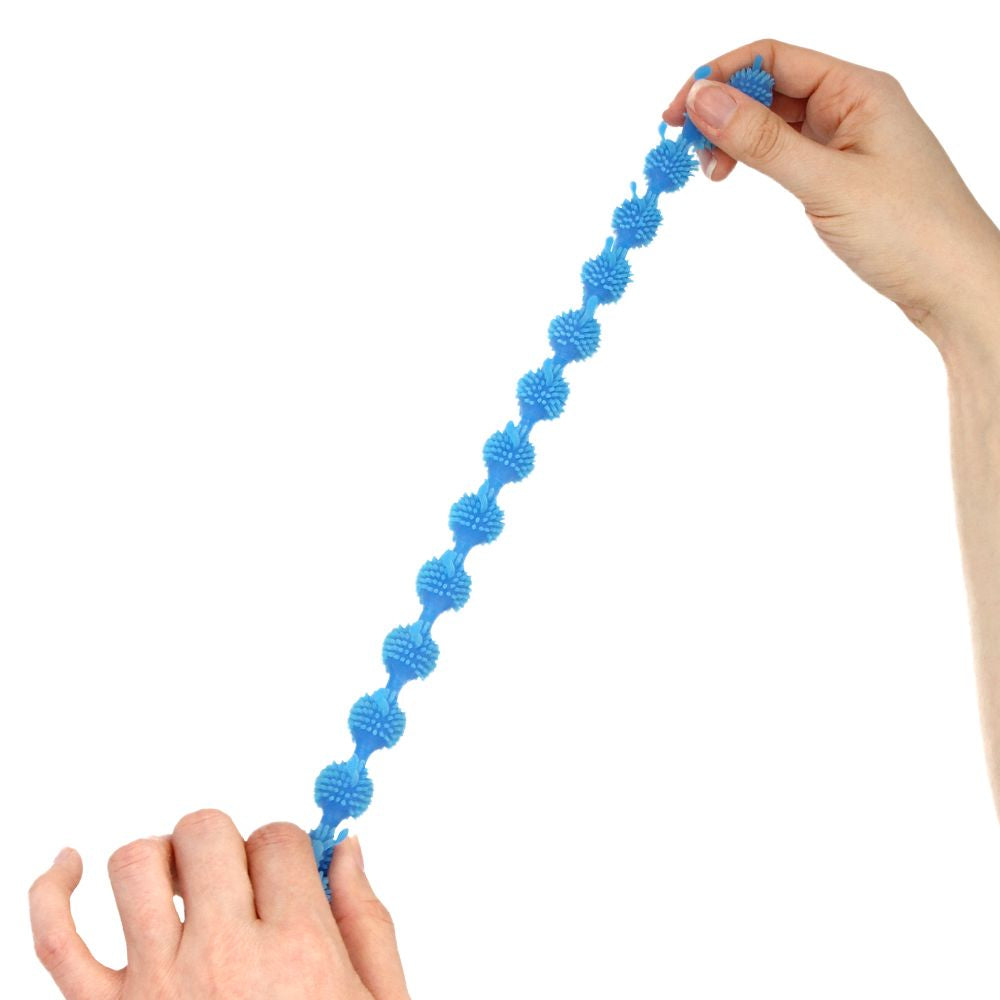Hands stretching a blue centipede fidget toy on a white backround