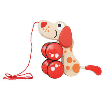 Wooden toy dog for Hape with red wheels and a pull along string on a white background